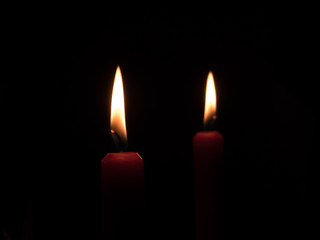 flame of a candlelight in the darkness