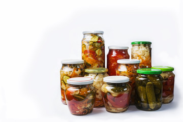 Glass jars with different colorful canned salads isolated on white background with place for text