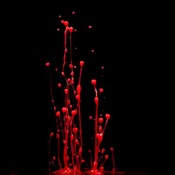 explosion of splashes and bursts of colour fluid paint or ink on a black background