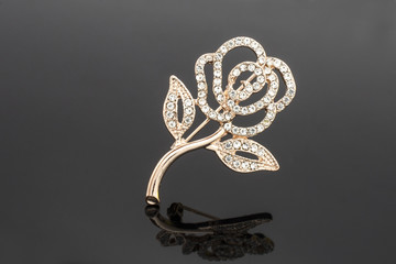 brooch rose flower with diamonds isolated on black