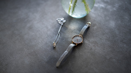 Fototapeta na wymiar Watch and Jewellery on Concrete table 