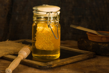 Honey in a jar with honey comb inside