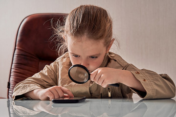 girl detective with magnifying glass and phone