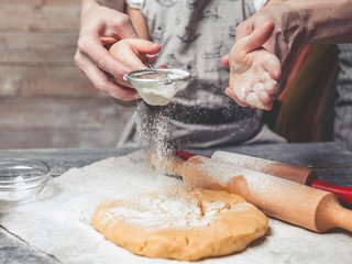 Mothers and children's hands flour dough. Home-made pastries