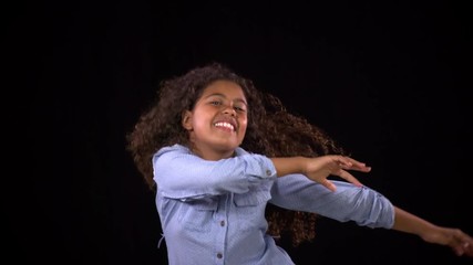 Cute girl dancing and swinging her hair around. Slow Motion.