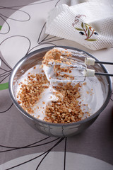 A bowl with whipped to solid peaks with sugar and peanuts