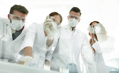 scientists working with test tubes and microscope in the laboratory