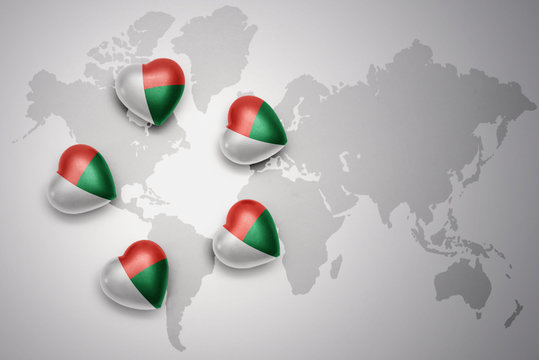five hearts with national flag of madagascar on a world map background