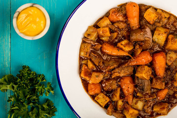 Beef and Red wine Casserole With Roast Potatoes Carrots and Mushrooms