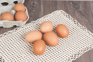 Brown eggs on wooden background