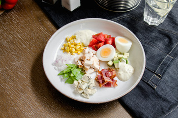 Healthy Hearty Cobb Salad with Chicken, Bacon, Tomato, Onions, Eggs, green beans. American food. Close up, home made