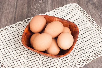 Brown eggs on wooden background