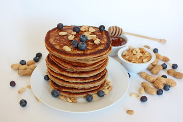 Healthy wholemeal pancakes with peanut butter and blueberries