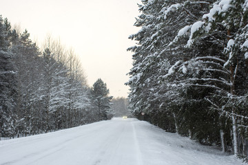 close-up car on a winter road in a blizzard