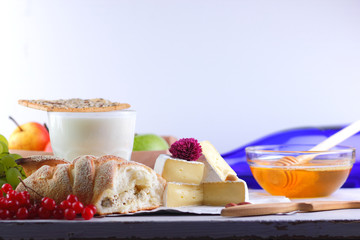 Cheese with mold, camembert with honey, purple bottle, Greek roll with cottage cheese, peanuts and pink flower, healthy food, milk in a glass with biscuits, pop art, retro style