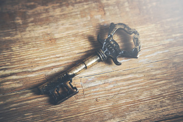 Old key on a wooden background