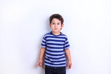 Cute little shy boy close up studio shoot on white. Emotions, childhood concept