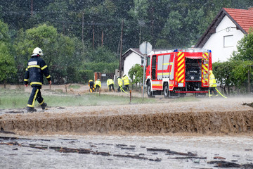 Fire department rushes to rescue when floods hit village in Europe after heavy rain - obrazy, fototapety, plakaty