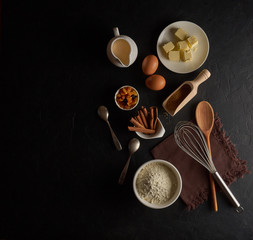 Ingredients for baking on black background top view