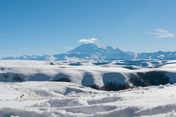 Fototapeta na wymiar The landscape of snow-covered Caucasian rocks on the Gumbashi Pass.
