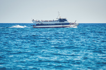 Touristic ship sailing in sea.