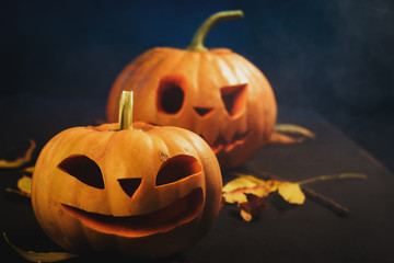 Halloween pumpkin lantern with dry leaves