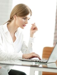 female assistant working on laptop in the office.