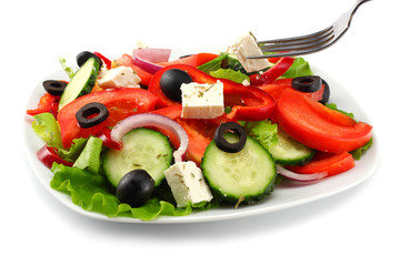 Square plate of greek salad isolated on white. fresh vegetable salad