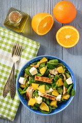 Grilled chicken fillet salad with oranges and brie.