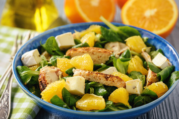 Grilled chicken fillet salad with oranges and brie.