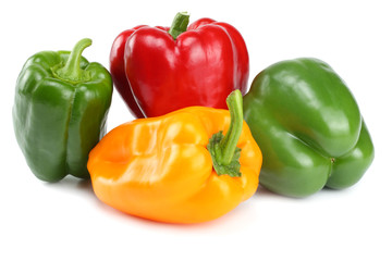 green, red, yellow sweet bell peppers isolated on white background