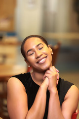 Black woman smiling and praying
