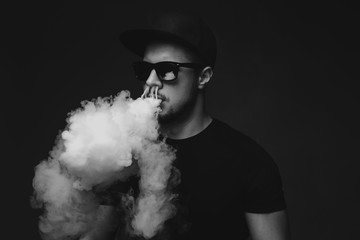 Vaping man and a cloud of vapor