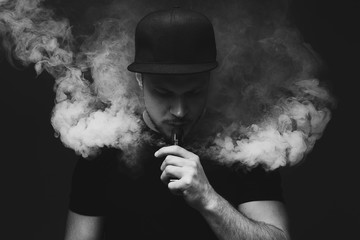Vaping man and a cloud of vapor