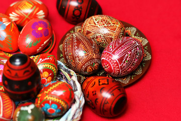 Traditional authentic ukrainian painted Easter eggs on red linen festive table cloth 