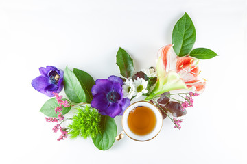 vintage, antique cup of tea decorated with flowers on white background in a shabby chic look
