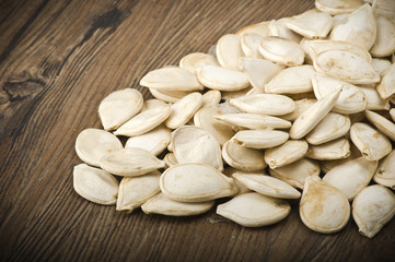 Dried pumpkin seeds on the wood table