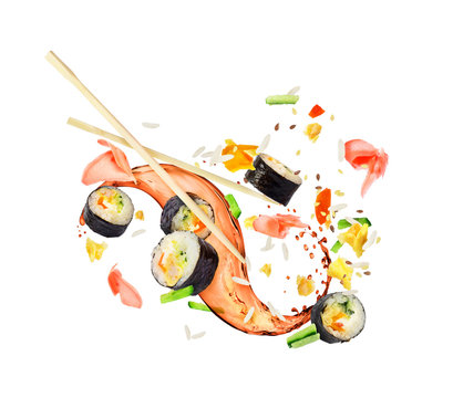 Sushi rolls frozen in the air in a chaotic order on a white background