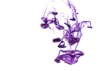 Color paint drops in water. Ink swirling underwater.