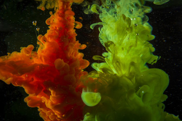 Color paint drops in water. Ink swirling underwater.