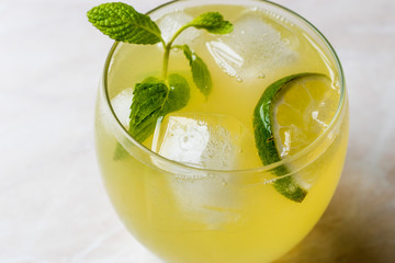 Yellow Lemonade Cocktail with Lime and ice.