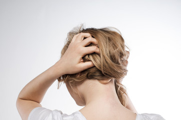 Fototapeta premium A young girl from the back with a strong headache.