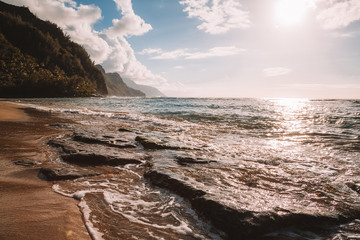 Beautiful sunset at the beach on the island of Kauai near Na Pali cliffs. Paradise island.