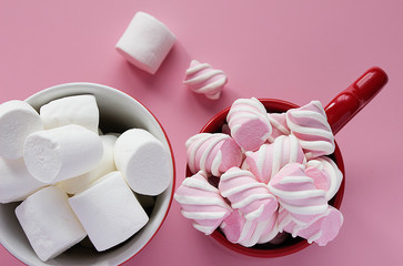 Close-up of marshmallow in cups on pink background.