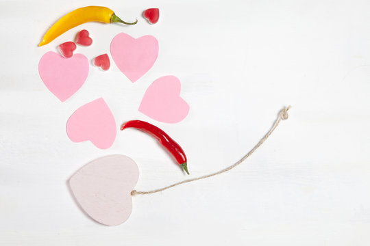the wooden, paper and marmalade hearts are on a wooden white wall