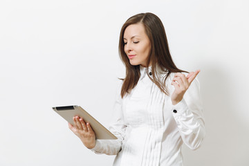Beautiful happy caucasian young smiling brown-hair business woman in white shirt holding and working in tablet isolated on white background. Manager, student or worker. Copy space for advertisement.
