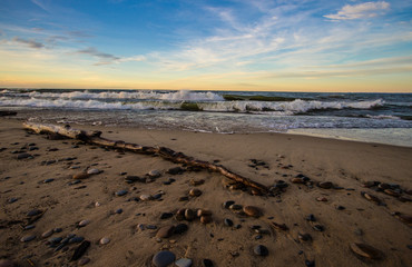 Summer Beach Background. Waves crash on the shore of Lake Superior at sunset along a remote coastal beach in the Upper Peninsula of Michigan.