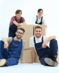 Satisfied and proud movers leaning on stack of boxes isolated on