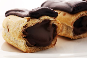 Traditional French dessert. Eclair with chocolate icing. Pastery concept