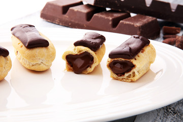 Traditional French dessert. Eclair with chocolate icing. Pastery concept